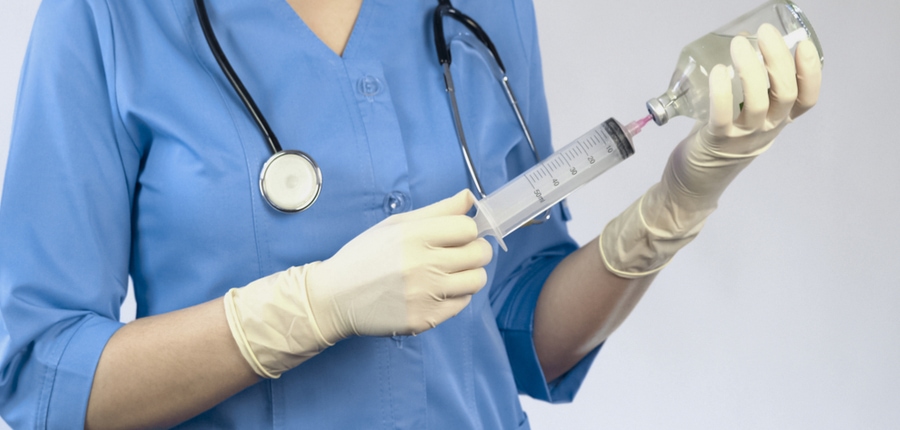 veterinarian is drawing medicine into syringe for euthanasia